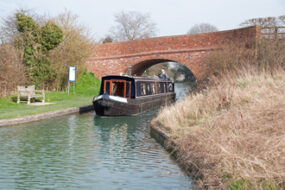 A narrow boat under Little Tring Bridge, which we had built with Heritage appearance